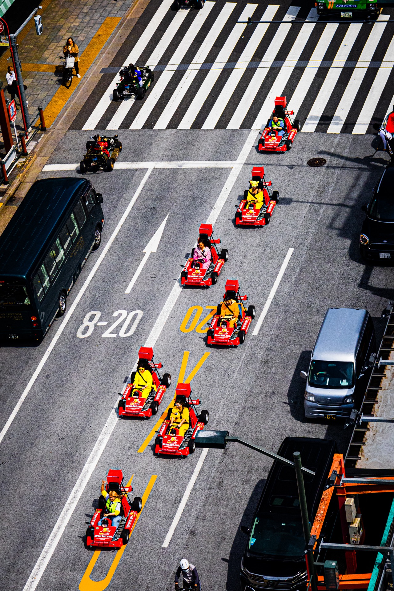 Mario karts driving through Tokyo streets, aerial